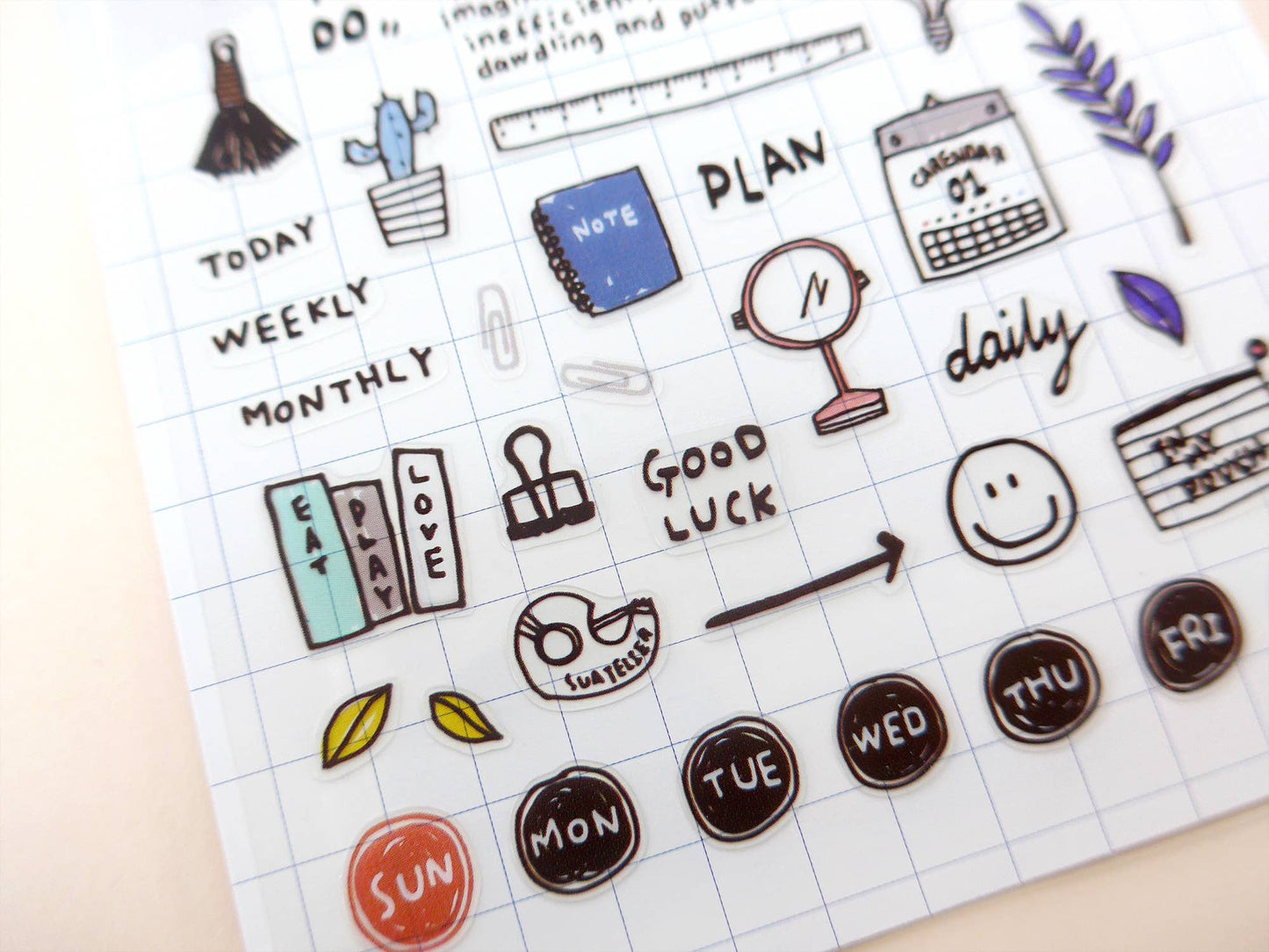 Collection of planner and stationery themed stickers on a grid background