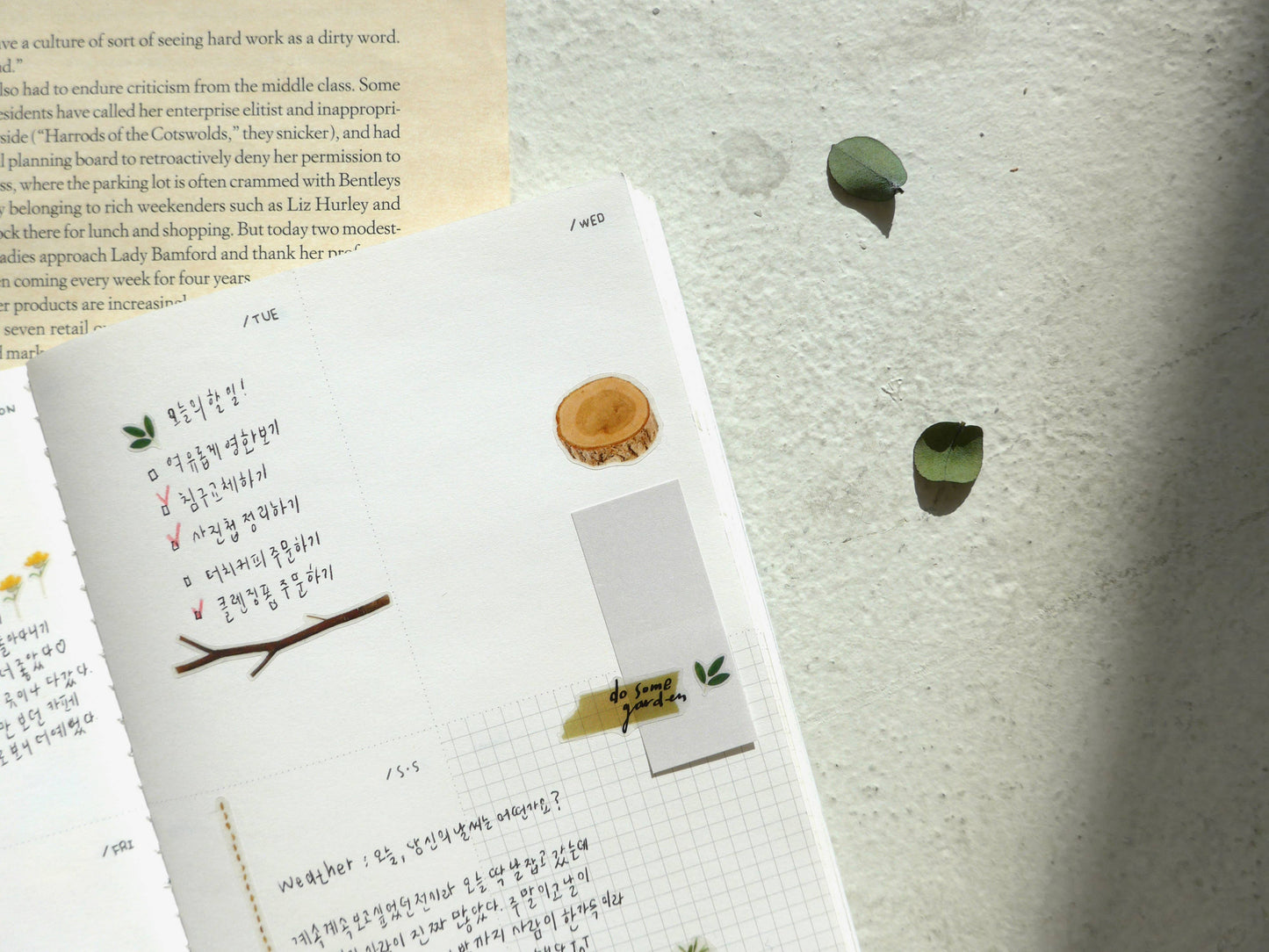 Notebook with nature-themed Suatelier stickers on a textured surface