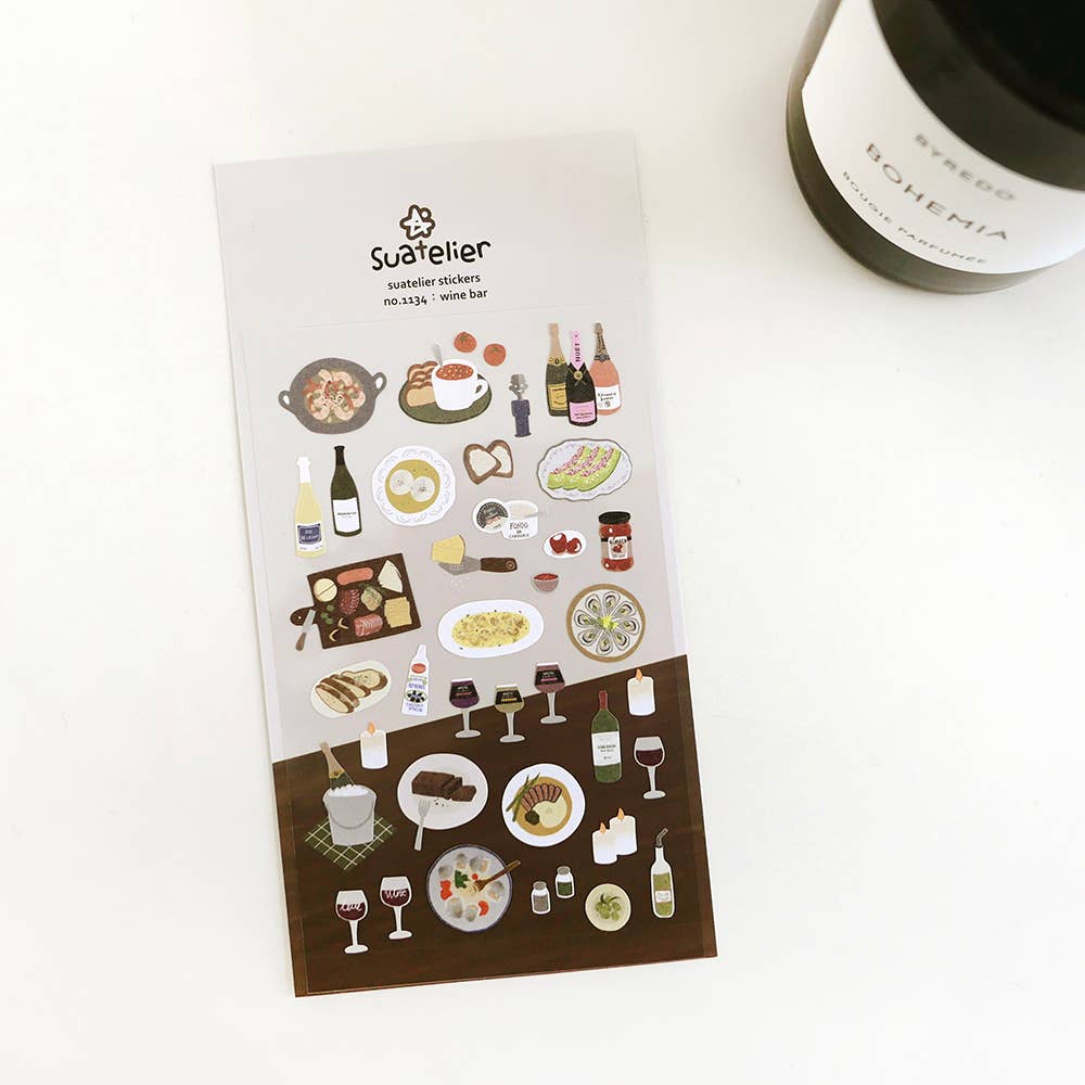 Sheet of decorative Suatelier stickers with food and drink illustrations on a white surface.