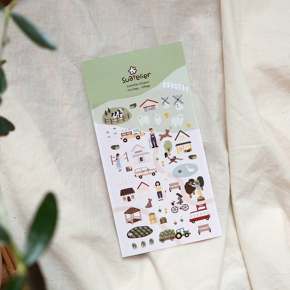 Sheet of decorative Suatelier stickers with various farm and country illustrations on a light fabric background