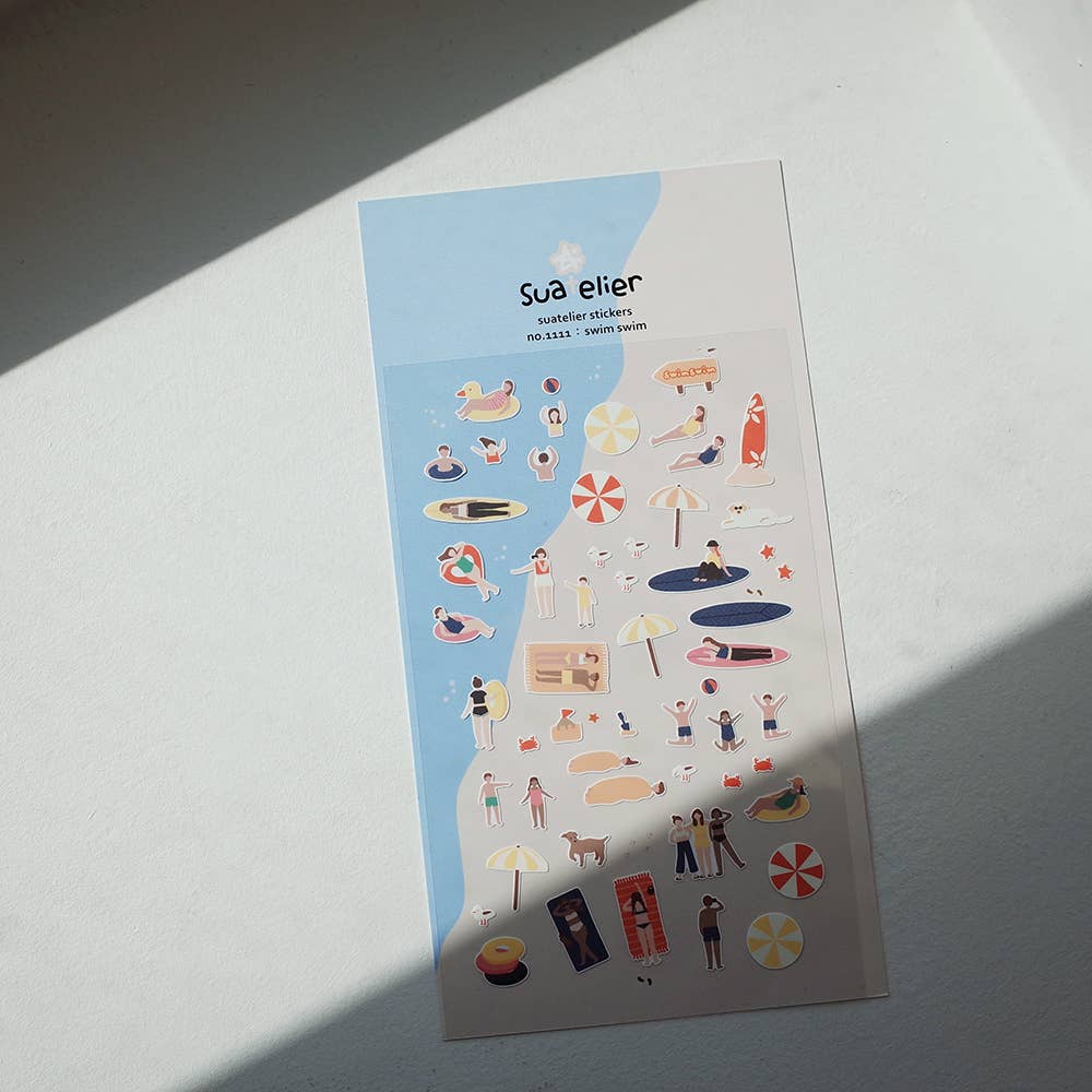 Sheet of decorative Suatelier stickers with various beach-themed illustrations on a light surface