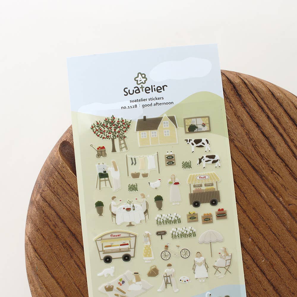 Sheet of stickers with various country style illustrations on a wooden surface