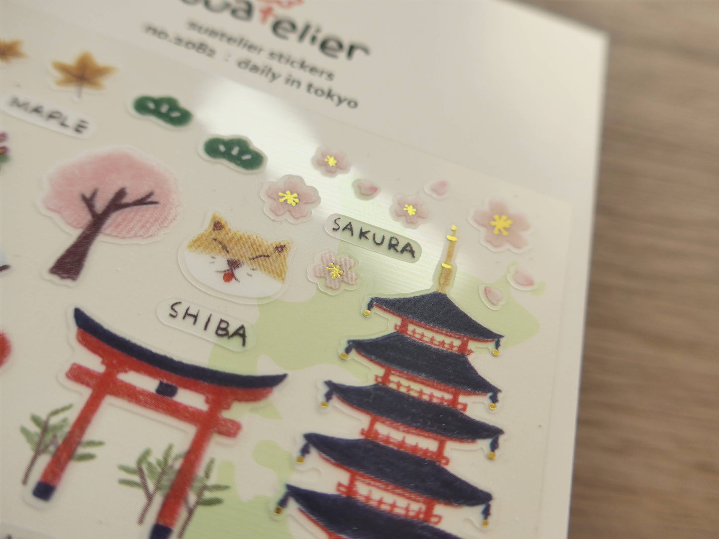 Sticker sheet with Japanese-themed illustrations including a shiba dog, cherry blossom tree, and torii gate.
