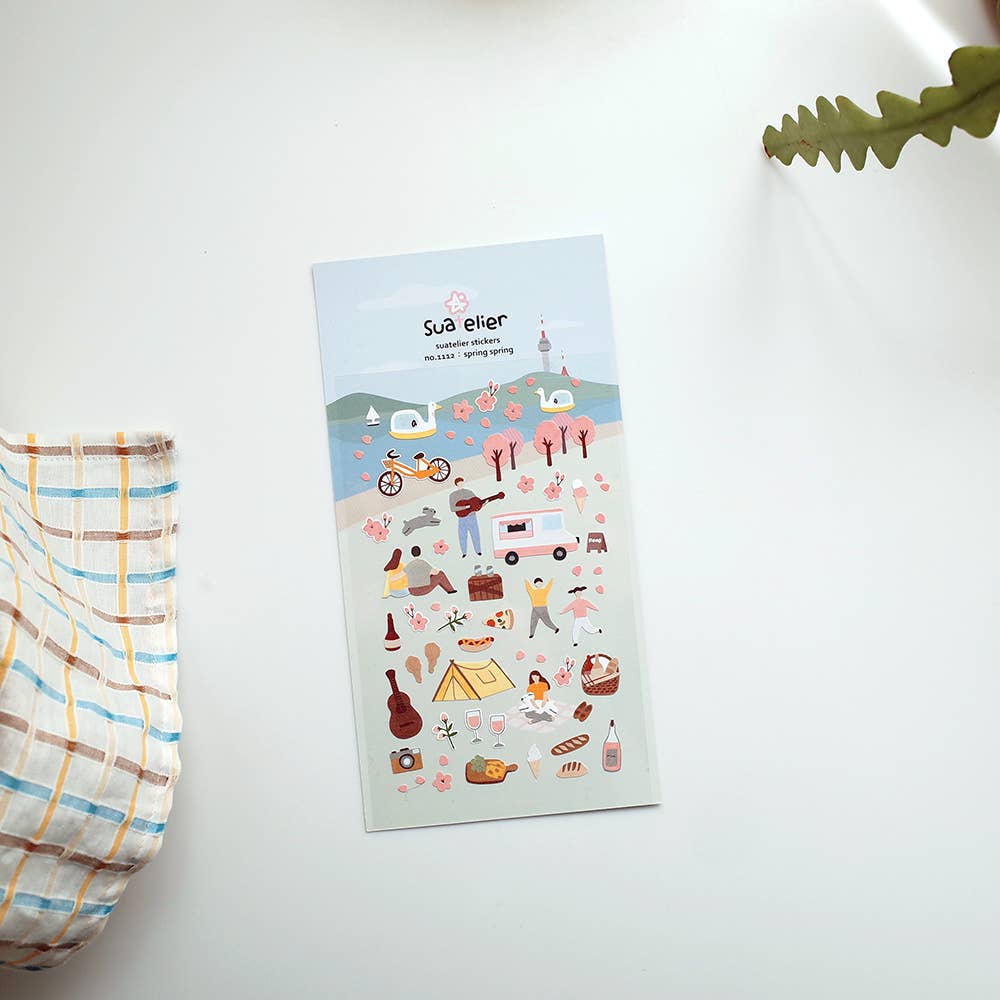 Sheet of illustrated Suatelier stickers with various spring designs on a white surface.