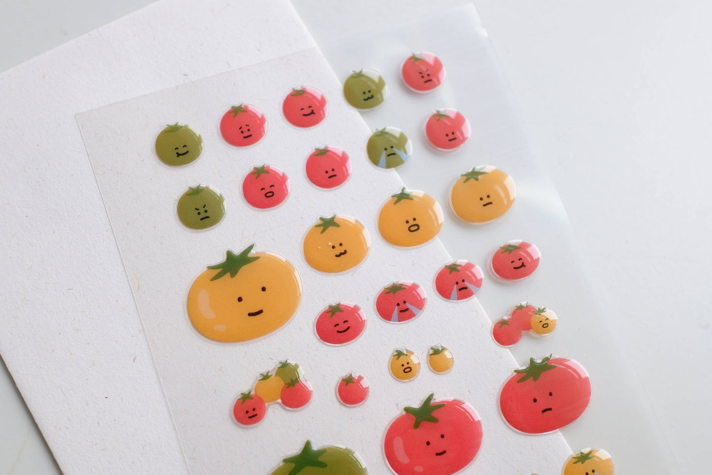 Sheet of colourful fruit-shaped stickers on a white background