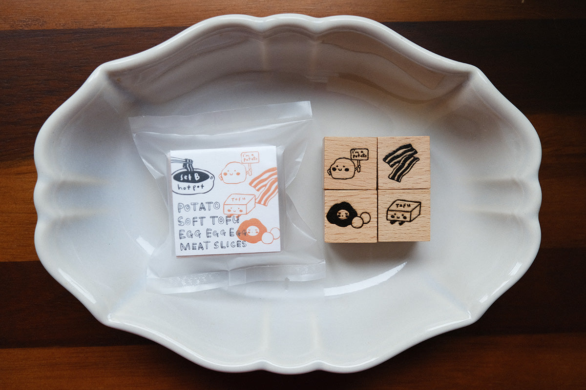Eileen Tai Hotpot stamps from Set B in a white ceramic dish