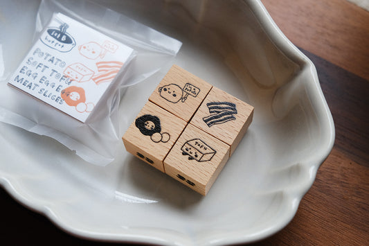 Eileen Tai Hotpot stamps from Set B in a white ceramic dish